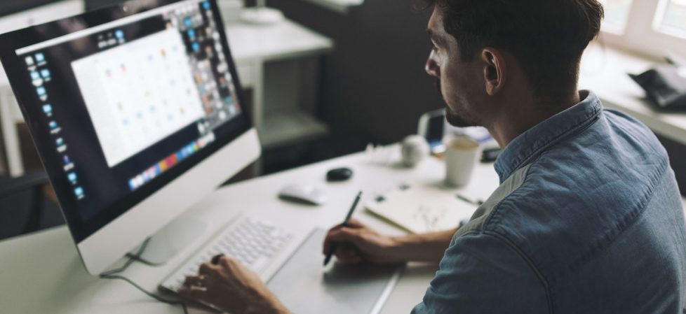 Young graphic designer working in office Design and DTP