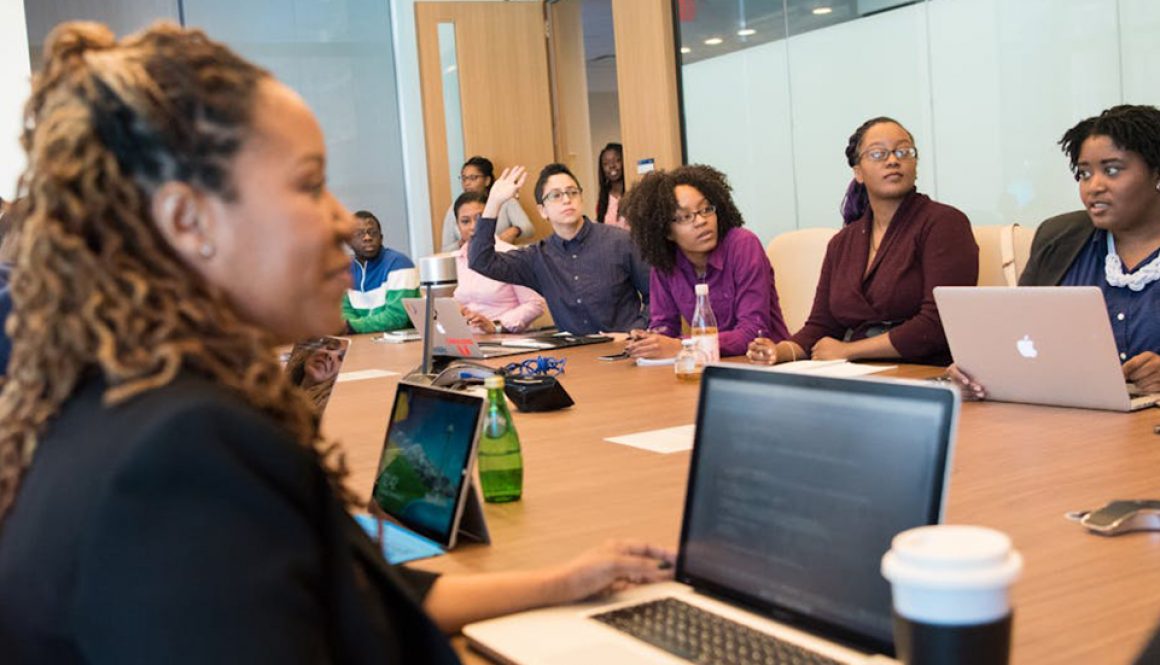 Group of adult learners, working on business English in an office session. Business English; language learning; learning a second language