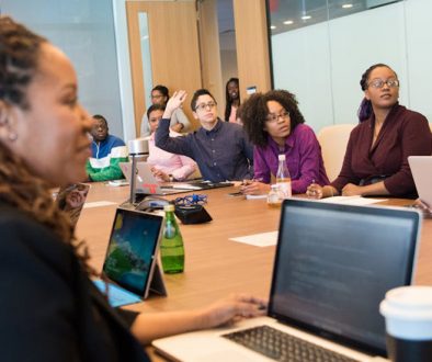 Group of adult learners, working on business English in an office session. Business English; language learning; learning a second language