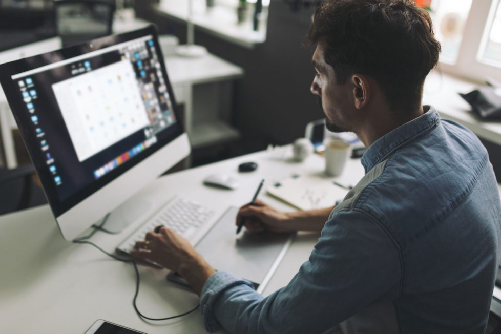 Young graphic designer working in office Young graphic designer working in office