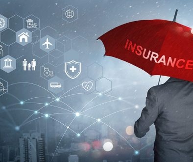 Concept of translating insurance documents — man holding an unbrella with the word "Insurance" looking at insurance options.