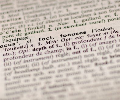 Close of a dictionary, artfully showing text.