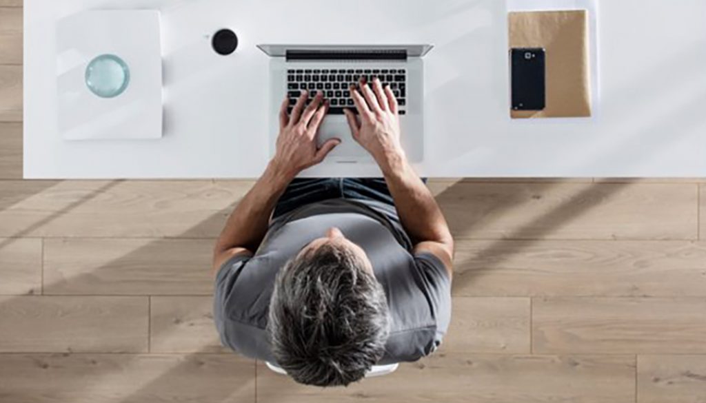Integrated DTP and translation: calm worker, at a clean desk.