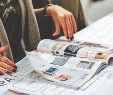 woman browsing through a magazine, multilingual content