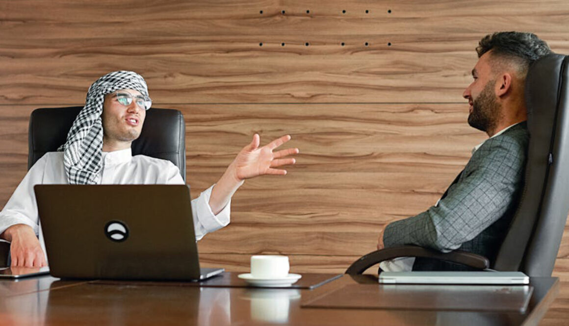 Two men, in an office environment, engaging in small talk in Business English.